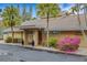 Clubhouse with a well-manicured lawn and colorful flowers, creating a welcoming and attractive community space at 5019 Village Gardens Dr # 31, Sarasota, FL 34234