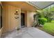 Charming front entrance featuring a covered porch, tiled flooring, and a well-lit address plaque at 5019 Village Gardens Dr # 31, Sarasota, FL 34234