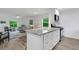 Bright kitchen with granite countertops, stainless steel appliances, and an open view to the living area at 5019 Village Gardens Dr # 31, Sarasota, FL 34234
