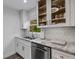 Modern kitchen featuring granite countertops, stainless steel appliances, and white cabinetry at 5019 Village Gardens Dr # 31, Sarasota, FL 34234