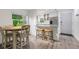 Bright kitchen with a breakfast bar, stainless steel refrigerator, and an open view to the dining area at 5019 Village Gardens Dr # 31, Sarasota, FL 34234