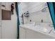 Functional laundry room with essential appliances, shelving, and a practical layout for efficient chores at 5019 Village Gardens Dr # 31, Sarasota, FL 34234