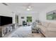 Bright living room featuring modern ceiling fan, glass sliding doors, neutral colors, and decorative rug at 5019 Village Gardens Dr # 31, Sarasota, FL 34234