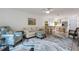 Cozy living room featuring an open layout with kitchen view, stylish furniture, and bright natural light at 5019 Village Gardens Dr # 31, Sarasota, FL 34234