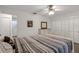 Bedroom featuring light wood floors, ceiling fan, walk in closet, and laundry access at 5019 Village Gardens Dr # 31, Sarasota, FL 34234