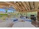 Outdoor grilling area with multiple grills and comfortable seating under a pavilion at 5019 Village Gardens Dr # 31, Sarasota, FL 34234