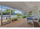 Enclosed patio with views of the pool area, complete with tables and seating at 5019 Village Gardens Dr # 31, Sarasota, FL 34234