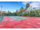 Enjoy the community's tennis court amid lush greenery and towering palms, perfect for recreation at 5019 Village Gardens Dr # 31, Sarasota, FL 34234