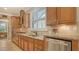Gourmet kitchen features stainless steel appliances, granite countertops, tile backsplash, and light wood cabinetry at 5361 Sundew Dr, Sarasota, FL 34238