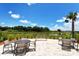 Outdoor patio area with tables, chairs, and a scenic view of the natural pond at 5361 Sundew Dr, Sarasota, FL 34238