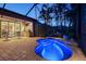 Cozy screened-in patio with a vibrant pool, outdoor kitchen, seating, and stylish brickwork perfect for evening relaxation at 5361 Sundew Dr, Sarasota, FL 34238