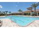 Large community pool with multiple lap lanes, sundeck with lounge chairs, and palm trees at 5361 Sundew Dr, Sarasota, FL 34238