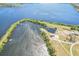 Beautiful aerial view of a large lake with a boat ramp and building, surrounded by lush landscaping at 5630 Simonton St, Bradenton, FL 34203