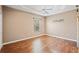 Well-lit bedroom boasts hardwood floors and neutral walls, creating a warm, inviting atmosphere at 5630 Simonton St, Bradenton, FL 34203
