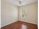 Bedroom featuring wood floors, a ceiling fan, and a window providing natural light at 5630 Simonton St, Bradenton, FL 34203