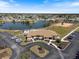 Aerial view of the community center, parking and lake, showcasing amenities and surrounding landscape at 6335 Granger Rd, Port Charlotte, FL 33981