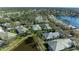 Scenic aerial view showcasing homes with lush green landscaping, serene lakes, and golf course at 6970 Mystic Ln, Sarasota, FL 34243