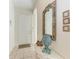 Foyer with tile flooring, elegant mirror, and decorative accents on a console table at 6970 Mystic Ln, Sarasota, FL 34243