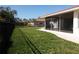 Lush backyard with screened-in patio and inviting seating area at 7431 Dickens Dr, Sarasota, FL 34231