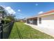 Well-maintained backyard features lush lawn, privacy fencing and screened patio at 7431 Dickens Dr, Sarasota, FL 34231