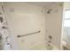 Bathroom featuring a tiled bathtub with shower and safety bars at 7431 Dickens Dr, Sarasota, FL 34231