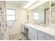Bathroom featuring a white vanity, countertop, and a well-lit mirror at 7431 Dickens Dr, Sarasota, FL 34231