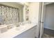 Bathroom featuring a white vanity with a makeup counter and neutral decor at 7431 Dickens Dr, Sarasota, FL 34231