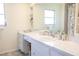 Bathroom showcasing a white vanity, countertop, and a well-lit mirror at 7431 Dickens Dr, Sarasota, FL 34231