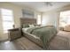 Comfortable bedroom featuring a queen bed, stylish rug, and access to a patio at 7431 Dickens Dr, Sarasota, FL 34231