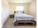 This bedroom showcases a storage platform bed, complemented by ample natural light and neutral wall colors at 7431 Dickens Dr, Sarasota, FL 34231