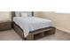 Bedroom showcasing a platform bed with storage and wood-look flooring at 7431 Dickens Dr, Sarasota, FL 34231