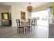 Bright dining room features wood table with seating for six and sliding glass doors to the backyard at 7431 Dickens Dr, Sarasota, FL 34231