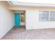Welcoming home entrance with a bright blue door, brick pathway, and neutral tones at 7431 Dickens Dr, Sarasota, FL 34231
