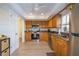 Eat-in kitchen features stainless steel appliances, ample wood cabinetry, and tile backsplash at 7431 Dickens Dr, Sarasota, FL 34231