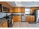 Eat-in kitchen features stainless steel appliances, ample wood cabinetry, and tile backsplash at 7431 Dickens Dr, Sarasota, FL 34231