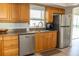 Stainless steel kitchen sink with window view and stainless steel refrigerator at 7431 Dickens Dr, Sarasota, FL 34231