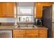 Stainless steel kitchen sink with window view and stainless steel refrigerator and counter at 7431 Dickens Dr, Sarasota, FL 34231