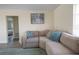 Comfortable living room with a sectional sofa, accent pillows, and an open doorway at 7431 Dickens Dr, Sarasota, FL 34231