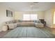 Spacious living room with a large sectional sofa, ceiling fan, and plenty of natural light at 7431 Dickens Dr, Sarasota, FL 34231