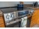 Close up of the stainless steel GE stove with glass top and digital display and light colored cabinets at 7431 Dickens Dr, Sarasota, FL 34231