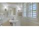 Bright bathroom with pedestal sink, charming fixtures, and window with natural light at 7715 Westmoreland Dr, Sarasota, FL 34243