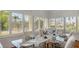 Formal dining room with a glass-top table, seating for six, and shutters allowing ample sunlight at 7715 Westmoreland Dr, Sarasota, FL 34243