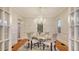 Bright dining room with a chandelier, hardwood floors, and large windows that let in natural light at 7715 Westmoreland Dr, Sarasota, FL 34243