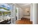 Inviting entryway with hardwood floors, stairs leading up, view of a patio with outdoor seating and a lush garden at 7715 Westmoreland Dr, Sarasota, FL 34243