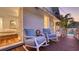 Cozy porch with rocking chairs, a small table, and a view of the side yard with the swimming pool at 7715 Westmoreland Dr, Sarasota, FL 34243