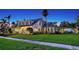 Stunning exterior view of the luxury home with lush green lawn at 7715 Westmoreland Dr, Sarasota, FL 34243