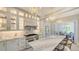 Luxurious kitchen with marble countertops, custom cabinetry, and a designer gas range with gold accents at 7715 Westmoreland Dr, Sarasota, FL 34243