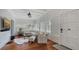 Sun-drenched living room featuring hardwood floors, bright white interior, and multiple shuttered windows at 7715 Westmoreland Dr, Sarasota, FL 34243