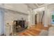 Elegant living room boasts a stone fireplace, hardwood floors, and beautiful french doors to the hallway at 7715 Westmoreland Dr, Sarasota, FL 34243