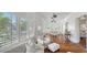 Open concept living and dining area with hardwood floors, white walls, and views to the outdoors at 7715 Westmoreland Dr, Sarasota, FL 34243